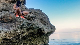 Climbing on the rock to pee in the sea