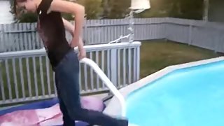 Girl jumps into pool with jeans